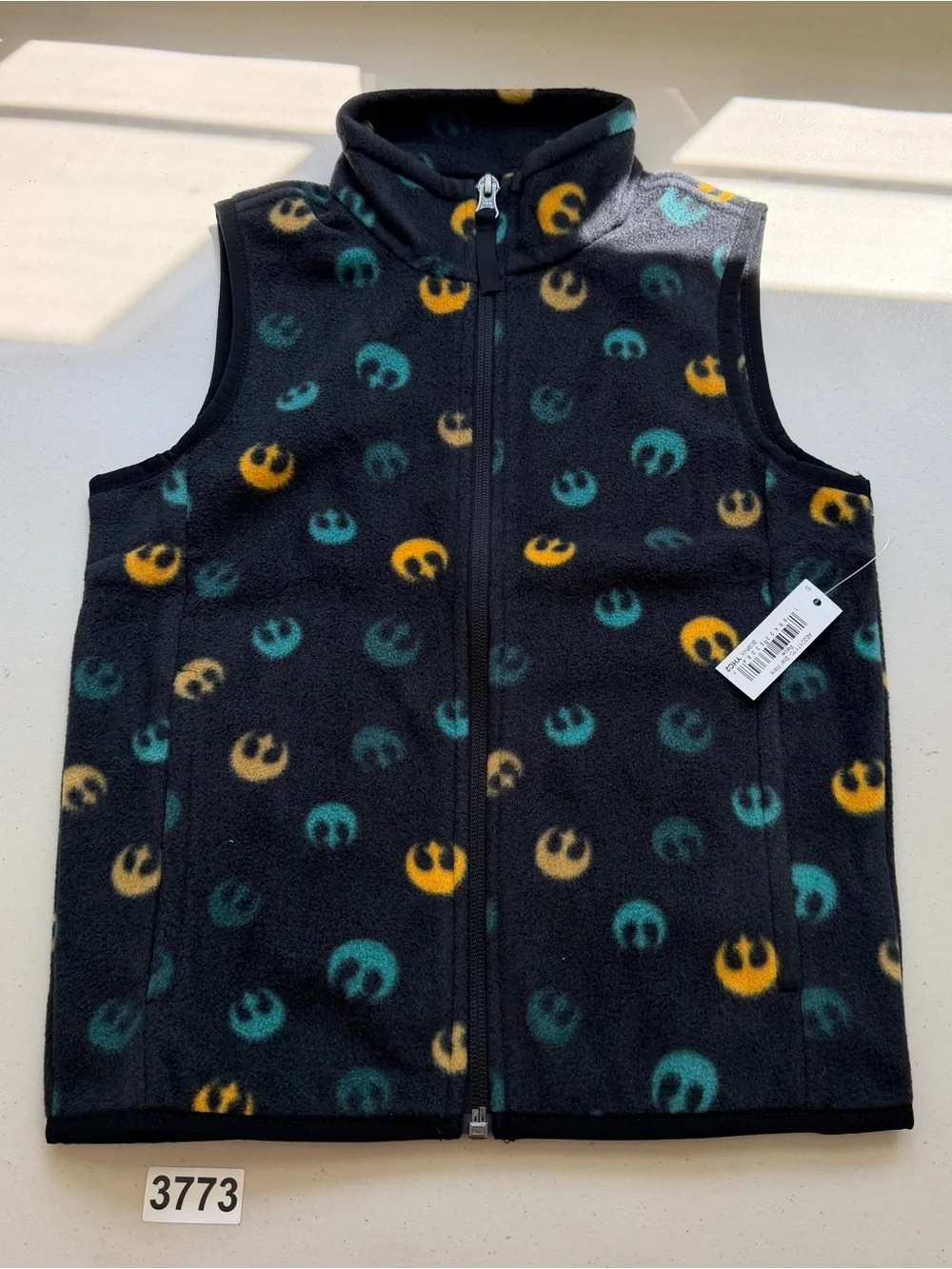 Sleeveless fleece vest featuring repeated Rebel Alliance emblems. Black base wit